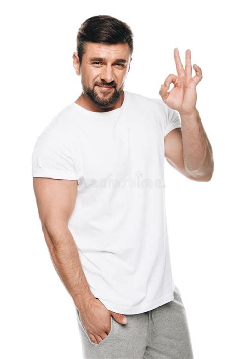 Portrait Of Handsome Man In White T Shirt Gesturing Ok Sign Stock Photo