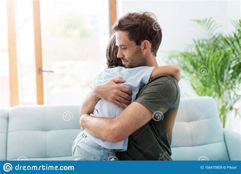 Father Embracing Son While Sitting On Sofa Stock Image - Image of happiness, carefree: 156470859
