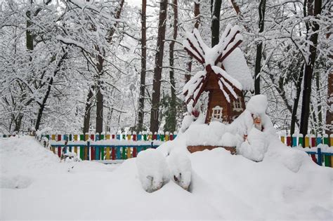 Decorative Windmill And Gnome Covered With Fresh Snow In Winter Park