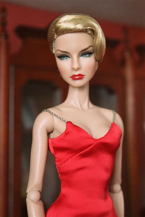 A Barbie Doll Wearing A Red Dress And Necklace