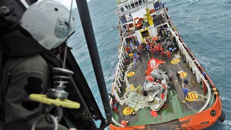 Indonesian navy divers hold wreckage from sriwijaya air flight sjy182 during a search. Both black boxes in AirAsia crash found in Java sea | The ...