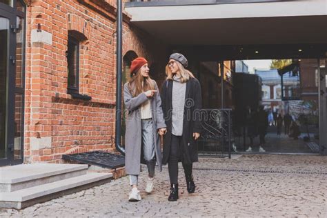 Two Girls Walking On Street Together They Are Wearing Spring Or Autumn