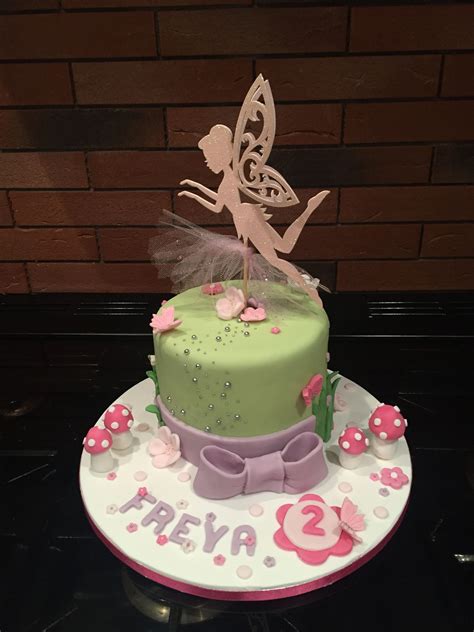 A Birthday Cake With A Fairy On Top
