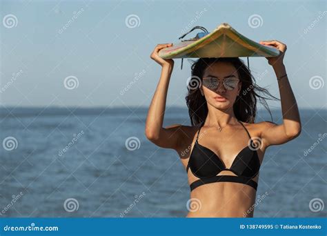 Portrait Of Gorgeous Dark Haired Girl In A Black Bra And Sunglasses