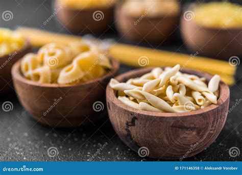 Close Up Of Different Dry Pasta Types Against Black Background Stock