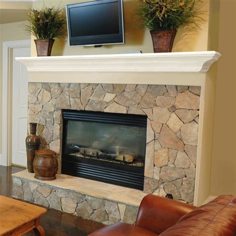 A Living Room With A Stone Fireplace And Television On The Mantel Above