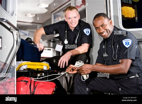 African American Paramedic In Back Of Ambulance With Co Worker Stock Photo Alamy