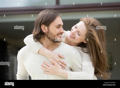 Young Wife Embracing Husband From His Back Enjoying Leisure Outs Stock
