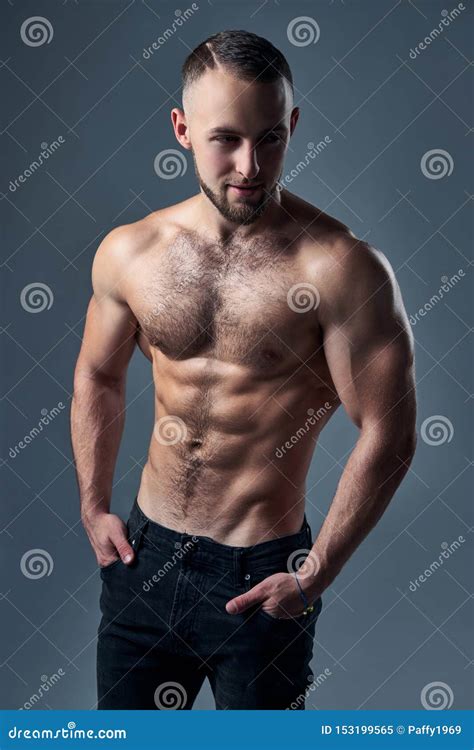 Muscular Shirtless Man Standing With Hands In Pockets Stock Image