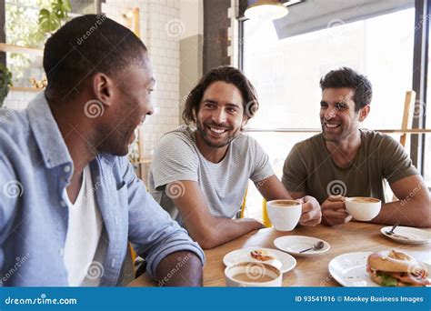 Three Male Friends Meeting For Lunch In Coffee Shop Stock Photo Image