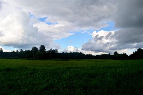 Black Storm Clouds During Summer Landscape With Trees And Meadows In