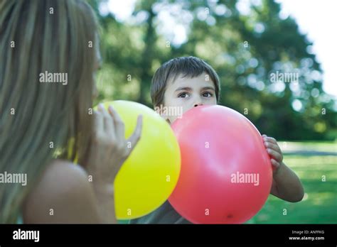Boy And Mother Blowing Up Balloons Stock Photo Alamy