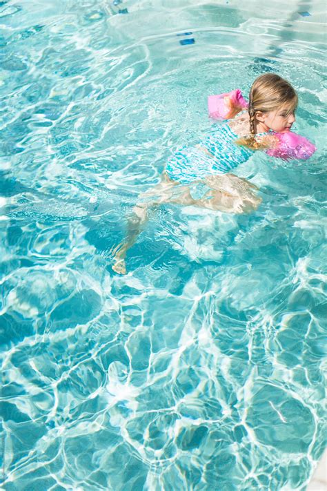 Young Girl Swimming In A Pool By Stocksy Contributor Skc Stocksy
