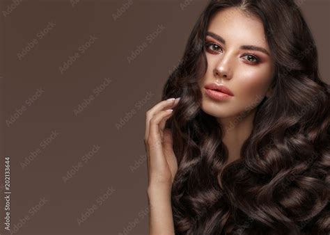Beautiful Brunette Model With Curls Classic Makeup And Full Lips The
