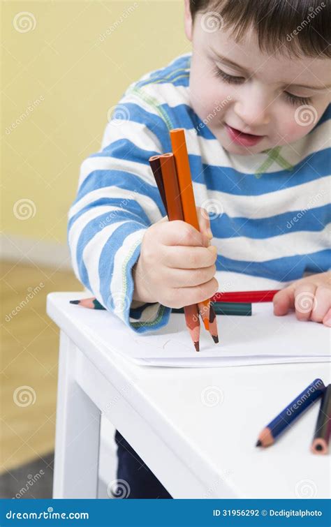 Young Boy Draws With Three Pencils Stock Photo Image Of Concentration