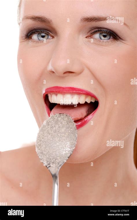 Woman Licking White Sugar Off A Spoon Stock Photo Alamy