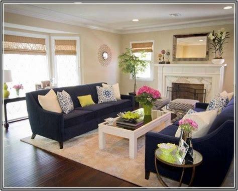 In this living room, a navy wall and sofa help set off the pinks in the pillows, rug and artwork. Navy Blue Couch Living Room Ideas | Blue couch living room ...