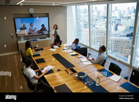 Business People Video Conferencing In Conference Room Meeting Stock