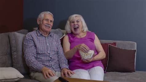 Overjoyed Old Mature Couple Football Fans Watching Sport Tv Game