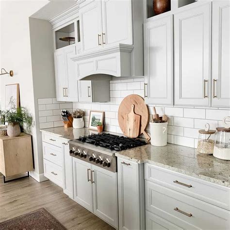 White Cabinets Mounted Above Subway Tile Backsplash With Granite Countertops Soul And Lane