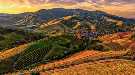 Village Surrounded By Green Covered Mountains Under Dusty Cloudy Sky 4k