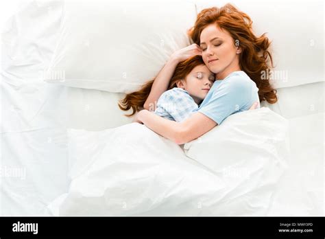 Beautiful Mother And Daughter Hugging And Sleeping Together In Bed