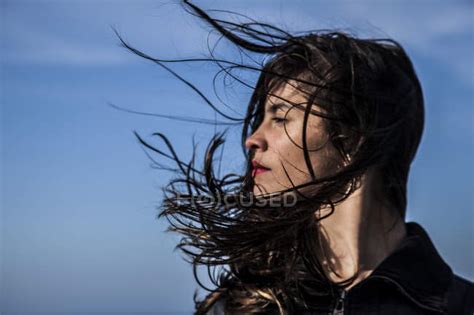 Young Woman With Hair Blowing On Wind — Caucasian Side View Stock