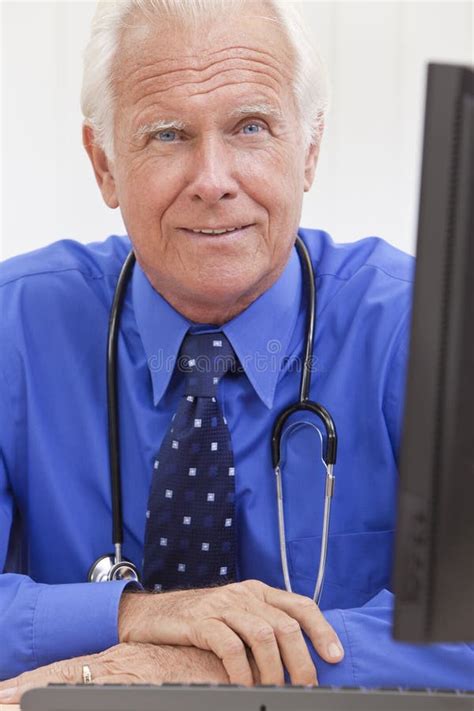 Senior Male Doctor With Stethoscope At Desk Stock Image Image Of