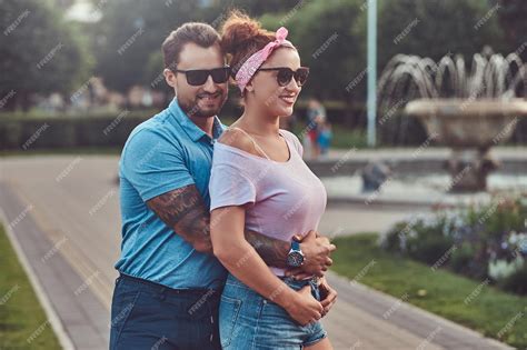 Premium Photo Bearded Male Hugs His Beautiful Redhead Wife While