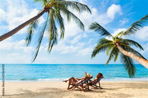 Couple Relax On The Beach Enjoying Beautiful Sea On The Tropical Island Stock Photo Adobe Stock