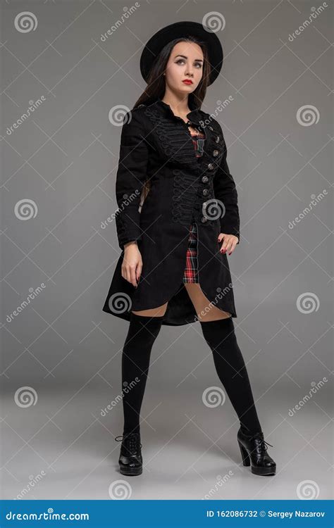 Full Length Portrait Of A Professional Model Posing At Studio Stock