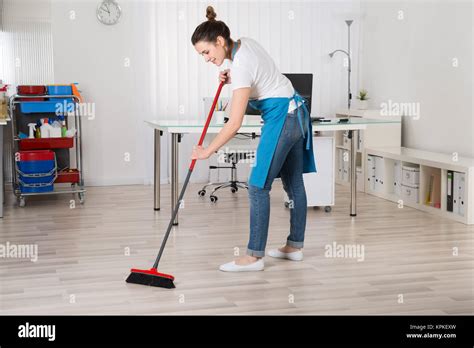 Female Janitor Sweeping Floor With Broom Stock Photo Alamy