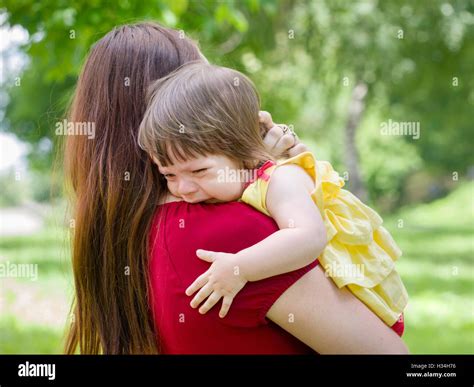Mother Holding Crying Baby Girl With Tears Stock Photo Alamy