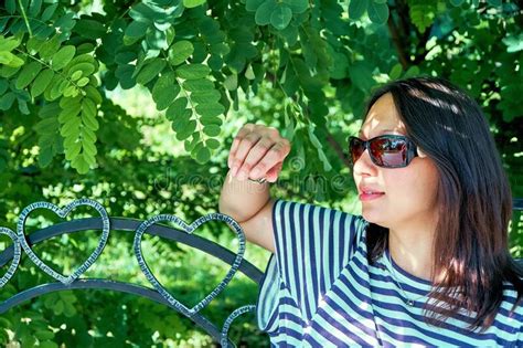 Pretty Woman In Stylish Blouse And Sunglasses In Park Stock Photo