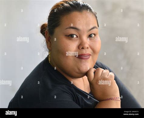 Chubby Professional Balinese Massage Therapist With Beautiful Eyes Poses For The Camera Stock