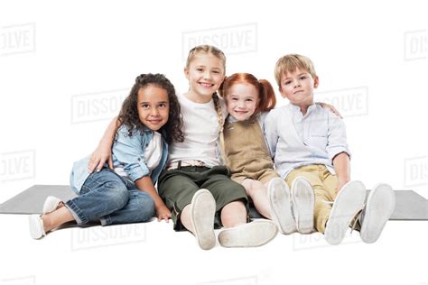Happy Multiethnic Children Sitting Together Isolated On White Stock