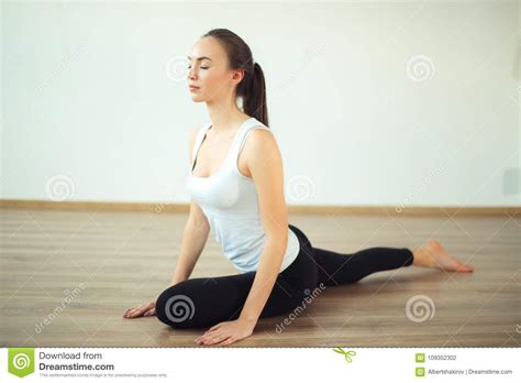 Woman Practicing Yoga Pose At Yoga Healthy Sport Gym Stock Photo