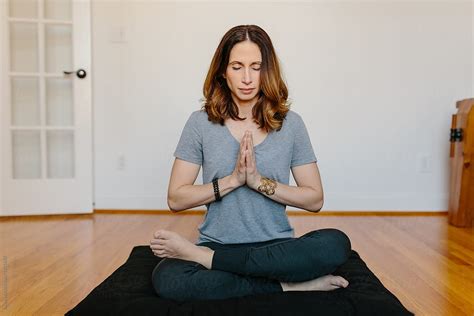 Ver Beautiful Woman Practicing Meditation At Home Del Colaborador De Stocksy Jakob Lagerstedt