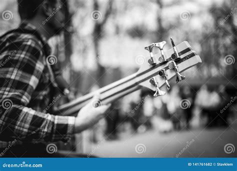 Black And White Photo Of Musician Playng On Six String Fretless Bass