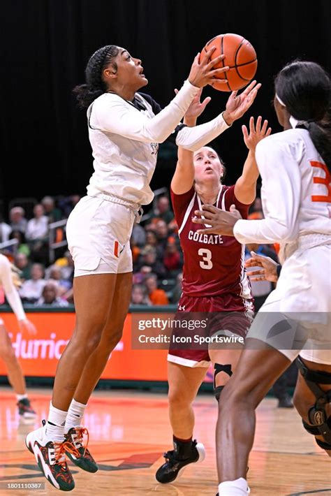 Miami Guard Lemyah Hylton Shoots A Jump Shot While Defended By News