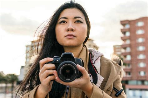 Ethnic Asian Female Photographer Shooting Photo On Professional Photo