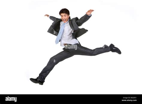 Young Businessman Jumping In Mid Air Stock Photo Alamy