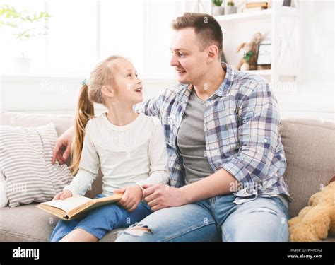Father And Daughter Talking About A Story They Read Stock Photo Alamy
