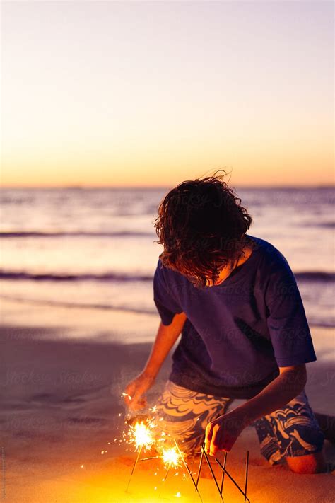 Babe Playing With Sparklers At The Beach At Night By Stocksy Contributor Angela Lumsden Stocksy