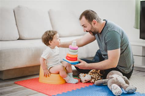 Father Training His Child To Use Potty Stock Photo Download Image Now