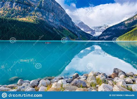 Man Riding A Canoe On Iconic Turquoise Lake Louise In The Canadian