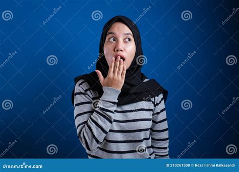 Asian Muslim Woman Wearing Hijab Closing Her Mouth With Fingers Stock