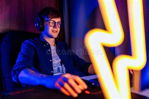 Gamer Playing Video Games On A Computer With Headphones And Using A