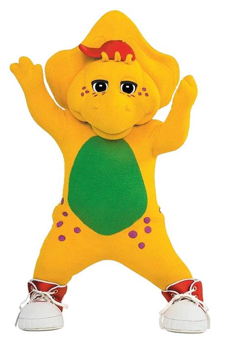 A Yellow Stuffed Animal With One Foot In The Air And Two Hands Out To
