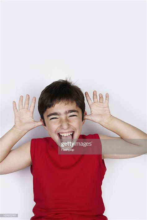 Portrait Of Boy Pulling A Funny Face High Res Stock Photo Getty Images